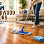 Homeowner cleaning hardwood floors with a microfiber mop in a bright modern living room with polished natural wood flooring.
